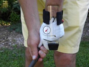 Close-up view of GOLFSTR locking the wrist when chipping