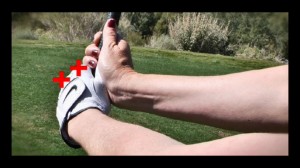To ensure that you are swinging with a flat wrist, check for 2 knuckles at address and in the backswing.