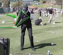 Sean OHair is demonstrating the first critical move in your backswing: Both arms straight to force the rotation of you chest 70 degrees away from the target line.